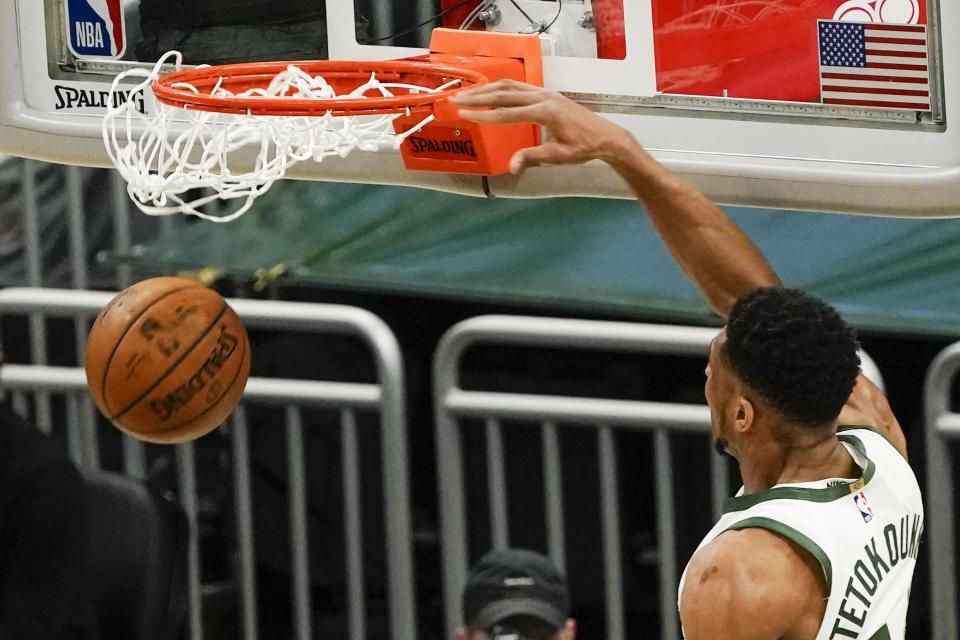 Milwaukee Bucks' Giannis Antetokounmpo dunks during the first half of an NBA basketball game against the Denver Nuggets Tuesday, March 2, 2021, in Milwaukee. (AP Photo/Morry Gash)