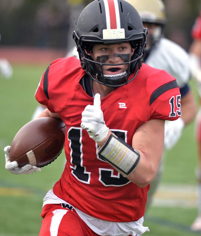 Wellesley High School football senior captain Sam Gear en route to a touchdown making the score 27-21 at the 134th annual Thanksgiving game, Nov. 25, 2021.