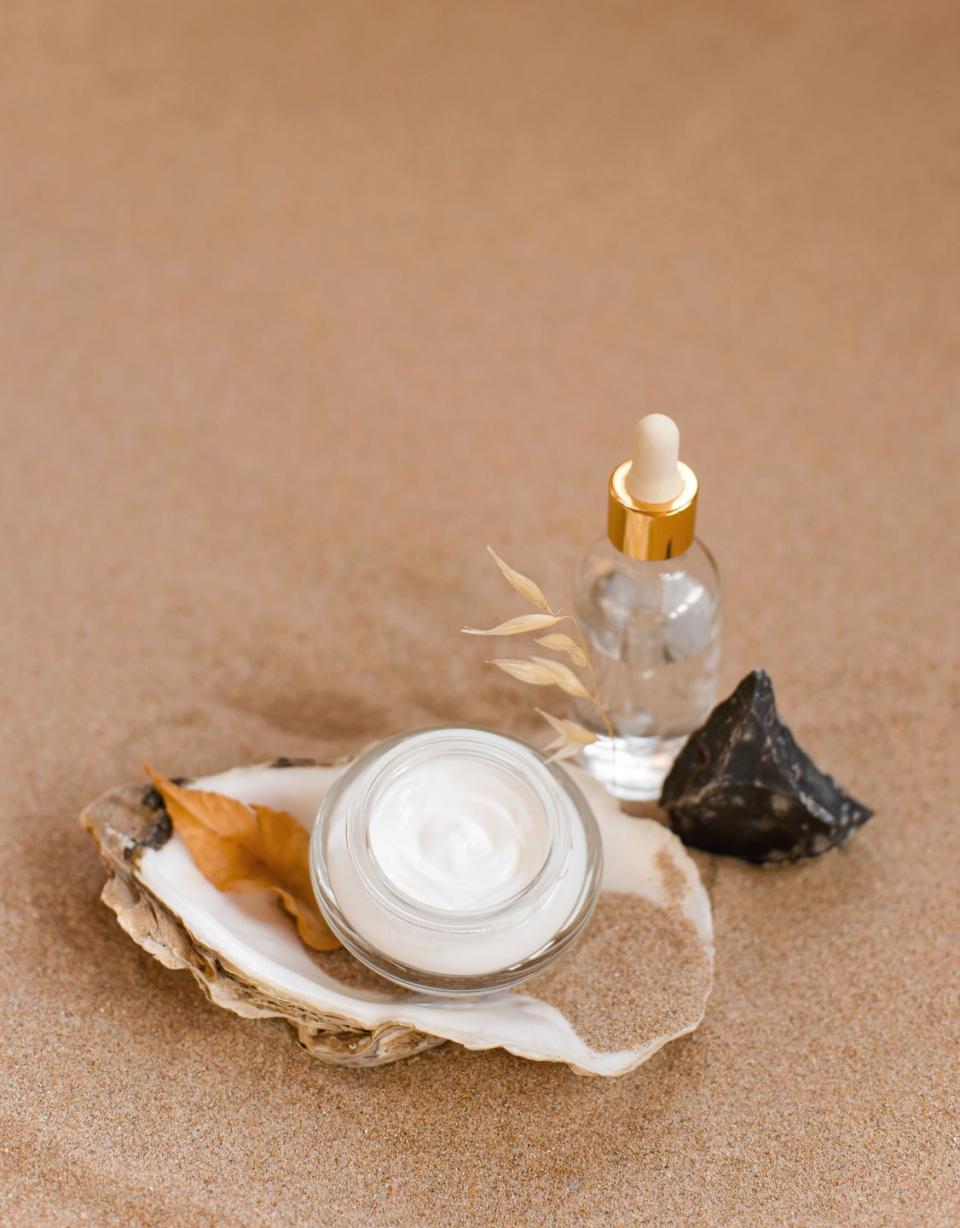 a plate of food and a bottle of perfume on a table