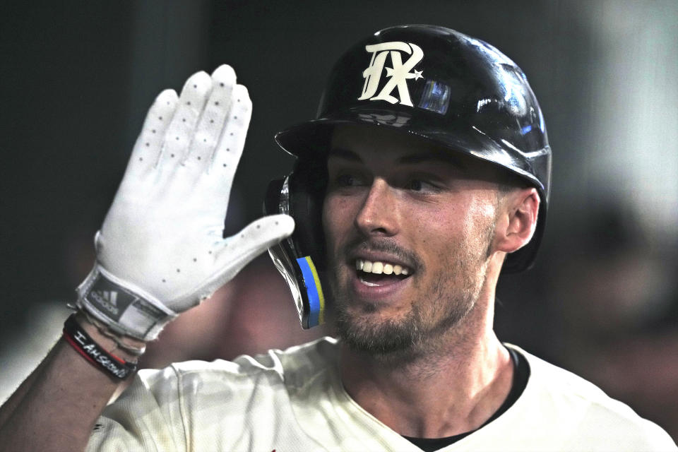 Texas Rangers' Evan Carter celebrates his three-run home run against the Seattle Mariners during the second inning of a baseball game in Arlington, Texas, Friday, Sept. 22, 2023. (AP Photo/LM Otero)