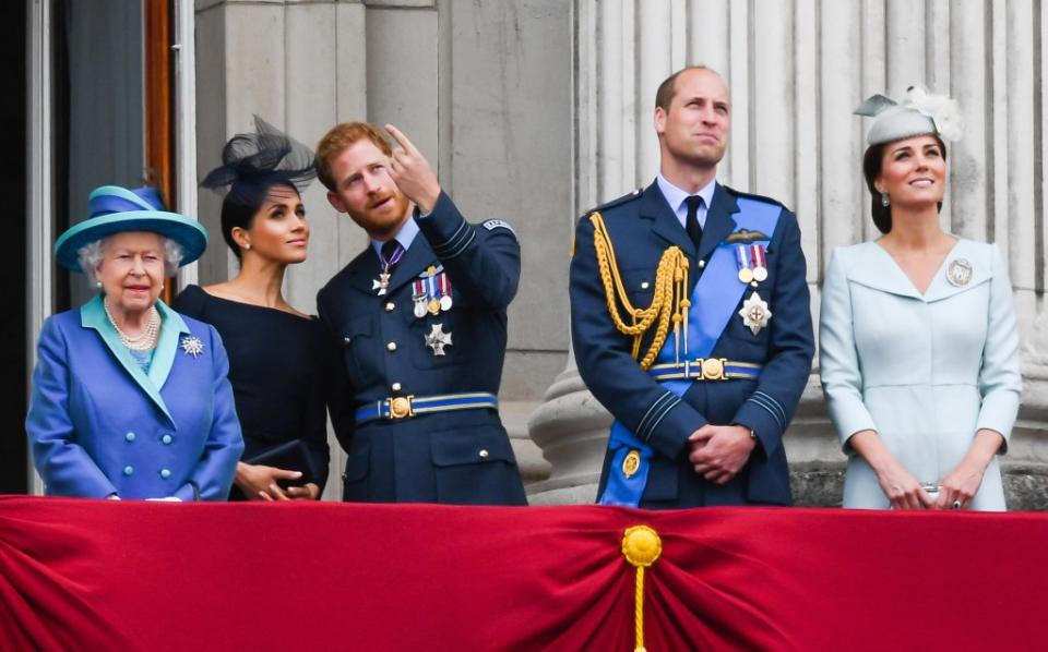 Queen Elizabeth ll, Meghan, Duchess of Sussex, Prince Harry, Duke of Sussex, Prince William, Duke of Cambridge and Catherine, Duchess of Cambridge stand on the balcony of Buckingham Palace to view a flypast to mark the centenary of the Royal Air Force on July 10, 2018, in London. WireImage