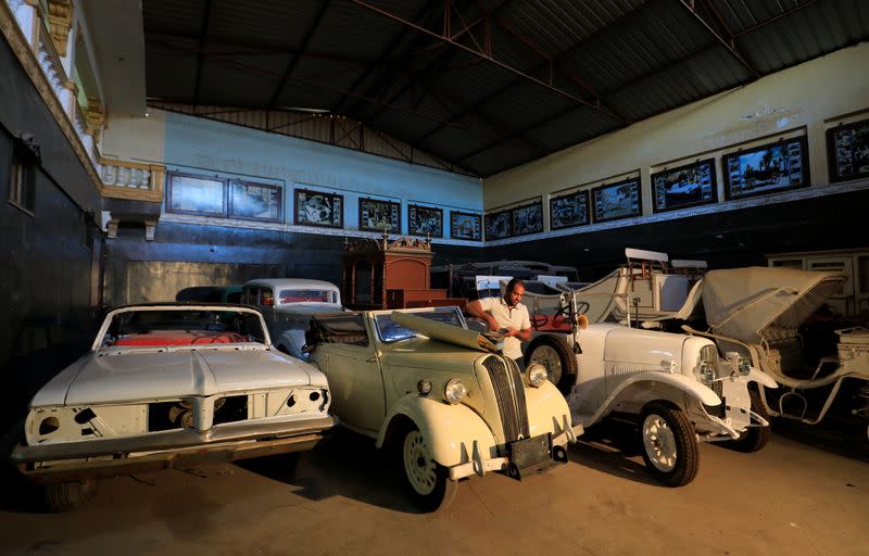 Ayman Sima, the 38-years-old son of Sayed Sima, an Egyptian collector of vintage cars, checks the battery of a British Standard Flying Eight Tourer - 1948 automobile at his father's store, in the Giza suburb of Abu Rawash