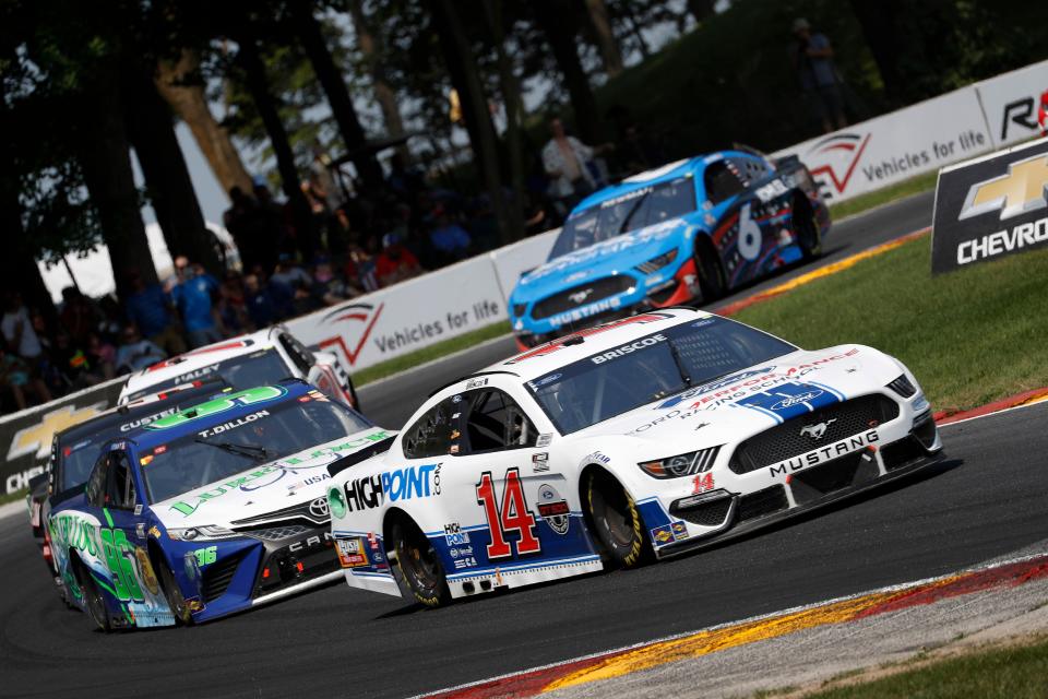 Mitchell's Chase Briscoe (14) leads a pack of cars through a turn at Road America. Briscoe will carry the Ford Performance Racing School colors back onto a road course Sunday at Sonoma Raceway.