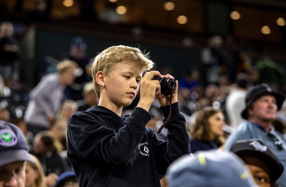 12-year-old Brody Carroll of Phoenix takes photos of a match between Iga Swiatek and Bianca Andreescu from his seat at the BNP Paribas Open at the Indian Wells Tennis Garden on Monday, March 13, 2023. Brody has an interest in photography, especially landscapes, but didn't pass up the chance to try his hand at a bit of sports photography.