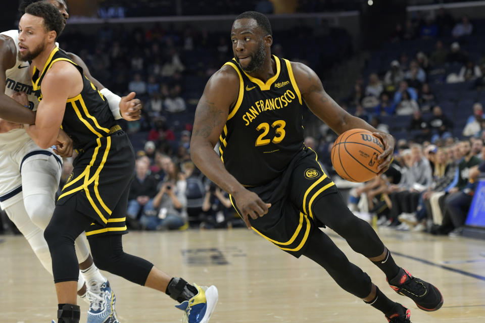 Golden State Warriors forward Draymond Green (23) handles the ball in the first half of an NBA basketball game against the Memphis Grizzlies, Monday, Jan. 15, 2024, in Memphis, Tenn. (AP Photo/Brandon Dill)