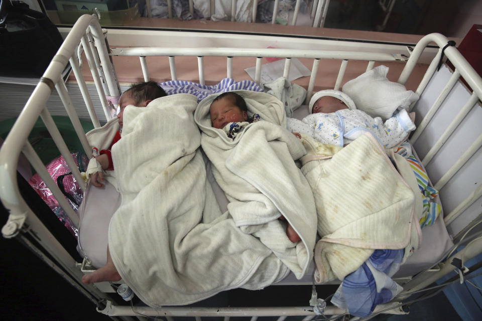 FILE - In this May 13, 2020, file photo, newborn babies lie in a bed at the Ataturk Children's Hospital a day after they were rescued following a deadly attack on another maternity hospital, in Kabul, Afghanistan. The United Nations on Sunday, June 21, 2020 released a special report expressing concerns over what it called recent “deliberate attacks” against healthcare workers and facilities in Afghanistan during the COVID-19 pandemic. (AP Photo/Rahmat Gul, File)