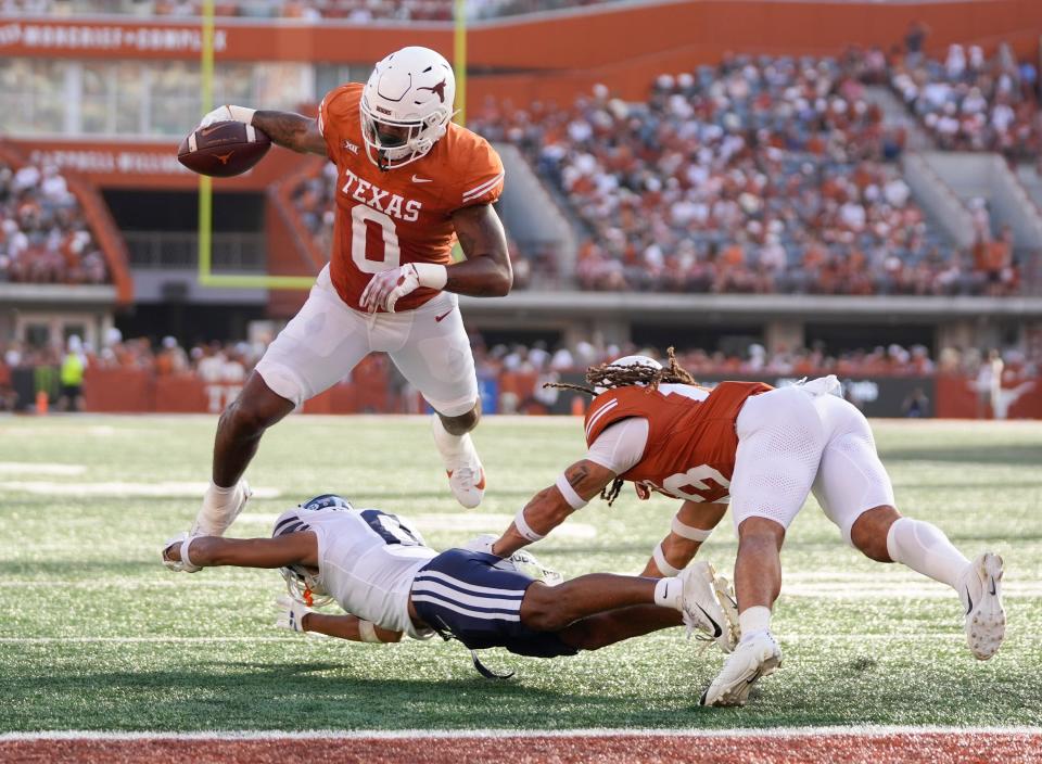 Texas Longhorns tight end Ja'Tavion Sanders is stopped by BYU Cougars cornerback Jakob Robinson on a fourth-down play in the red zone in the third quarter at Royal-Memorial Stadium on Saturday October 28, 2023.