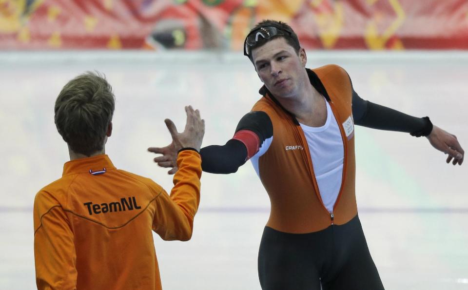 Silver medallist Sven Kramer of the Netherlands, facing camera, congratulates teammate and gold medallist Jorrit Bergsma after the men's 10,000-meter speedskating race at the Adler Arena Skating Center during the 2014 Winter Olympics in Sochi, Russia, Tuesday, Feb. 18, 2014. (AP Photo/David J. Phillip )