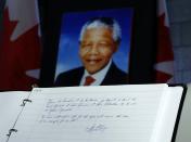 A message left by Canada's Prime Minister Stephen Harper is pictured in a book of condolence for former South African President Nelson Mandela on Parliament Hill in Ottawa December 6, 2013. REUTERS/Chris Wattie (CANADA - Tags: POLITICS OBITUARY)