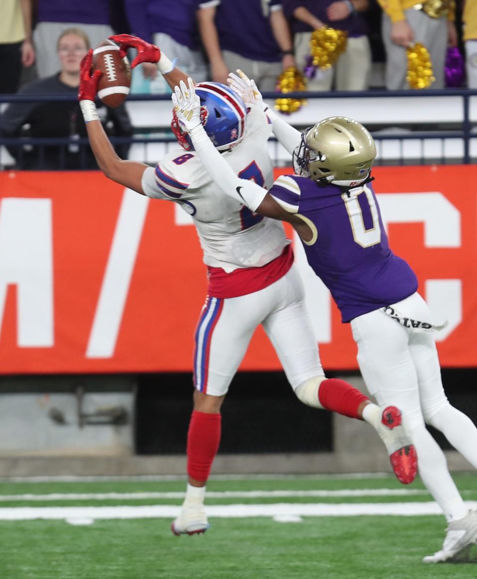 Carmel's Damien Santiago catches a pass in front of Christian Brothers Academy Zion Green (00) during the New York State Class AA championship at the JMA Dome in Syracuse Dec. 3, 2023.