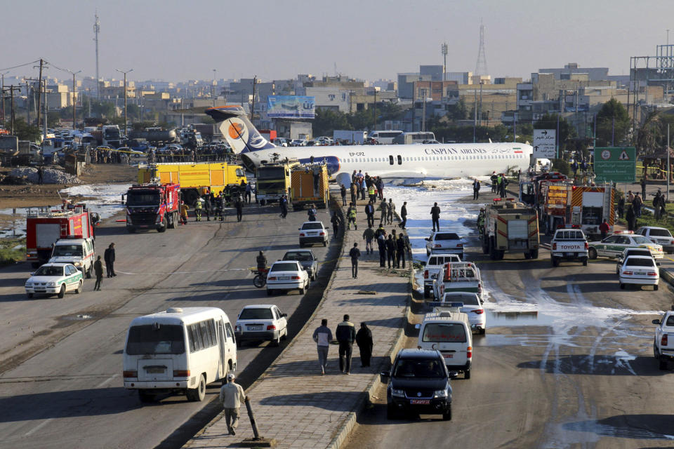 An Iranian passenger plane sits on a road outside Mahshahr airport after skidding off the runway, in southwestern city of Mahshahr, Iran, Monday, Jan. 27, 2020. An Iranian passenger airliner carrying some 150 passengers skidded off the runway and into a street next to the airport in the southern city of Mahshahr on Monday, after apparently losing its landing gear in a hard landing. (Mohammad Zarei/ISNA via AP)