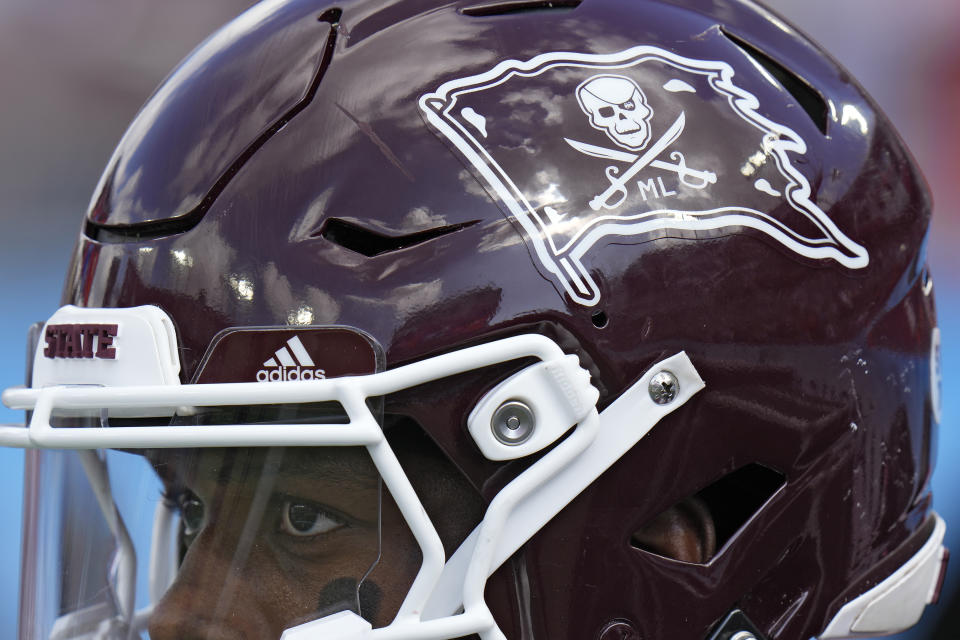 Mississippi State running back Jo'quavious Marks and the rest of the team wear stickers on their helmets in honor of former coach Mike Leach during the first half of the ReliaQuest Bowl NCAA college football game against Illinois Monday, Jan. 2, 2023, in Tampa, Fla. Leach passed away Dec. 13, 2022, from a heart condition. (AP Photo/Chris O'Meara)