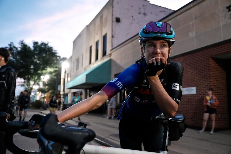 a man wearing a helmet and riding a bicycle