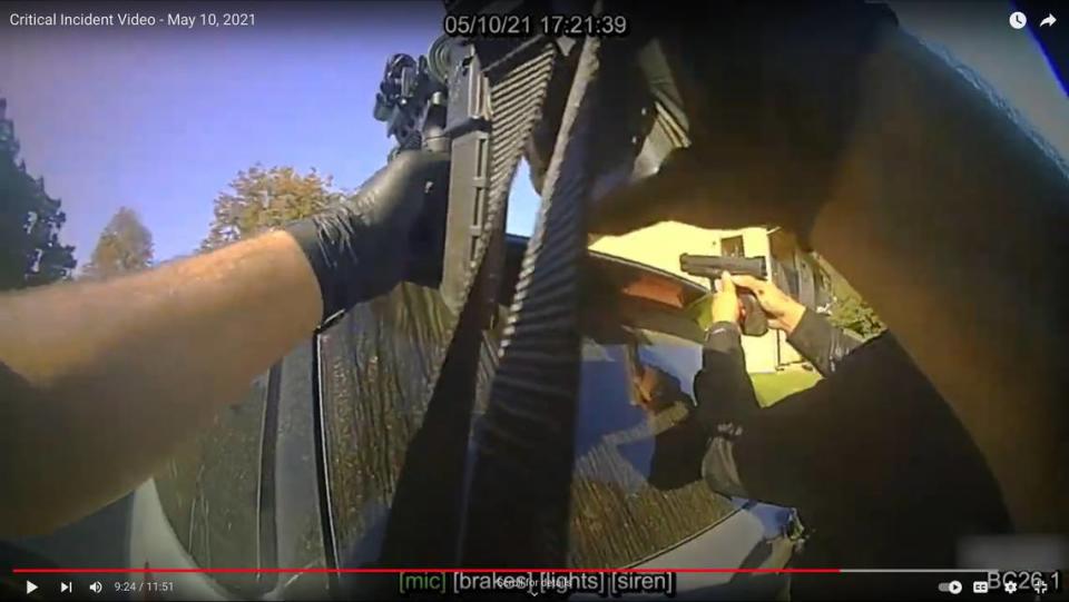 In a screenshot from body camera video, a police officer checks on Det. Steve Orozco, who was injured after being shot by Edward Giron while serving a search warrant at Giron’s Camellia Court apartment in San Luis Obispo on May 10, 2021.  Giron shot and killed Det. Luca Benedetti in the incident.