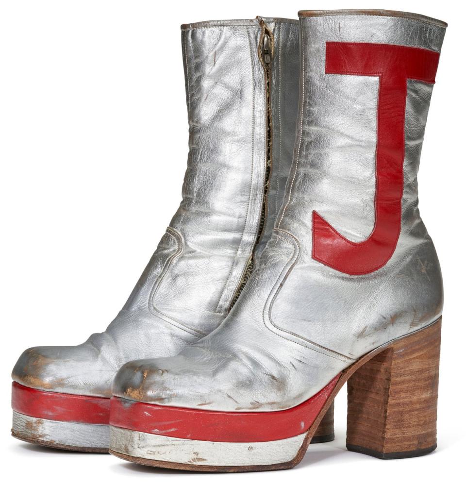 Sir Elton John’s silver leather platform boots, embroidered in bright red with the letters EJ, will go up for auction with an estimated price of $5,000 to $10,000 (£3,900 to £7,900) (PA)