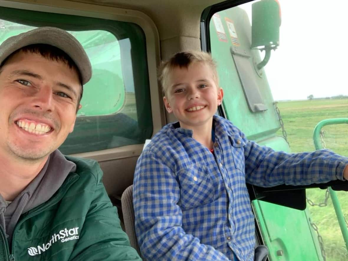 Walter, left, and Hayden Smith work the fields of their family farm. (Submitted by Walter Smith - image credit)