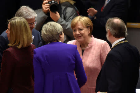 German Chancellor Angela Merkel talks with British Prime Minister Theresa May as they attend a European Union leaders summit in Brussels, Belgium, March 22, 2018. REUTERS/Eric Vidal/Pool