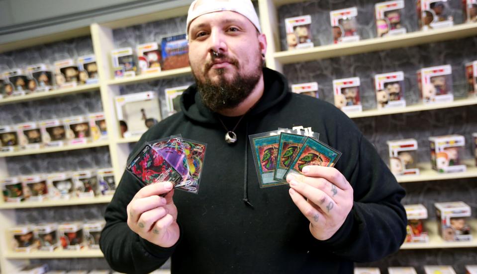 Steven Baker, owner of The King's Court in Taunton, at the new gaming and collectibles store on Thursday, March 31 preparing for an April Fools' Day soft opening.