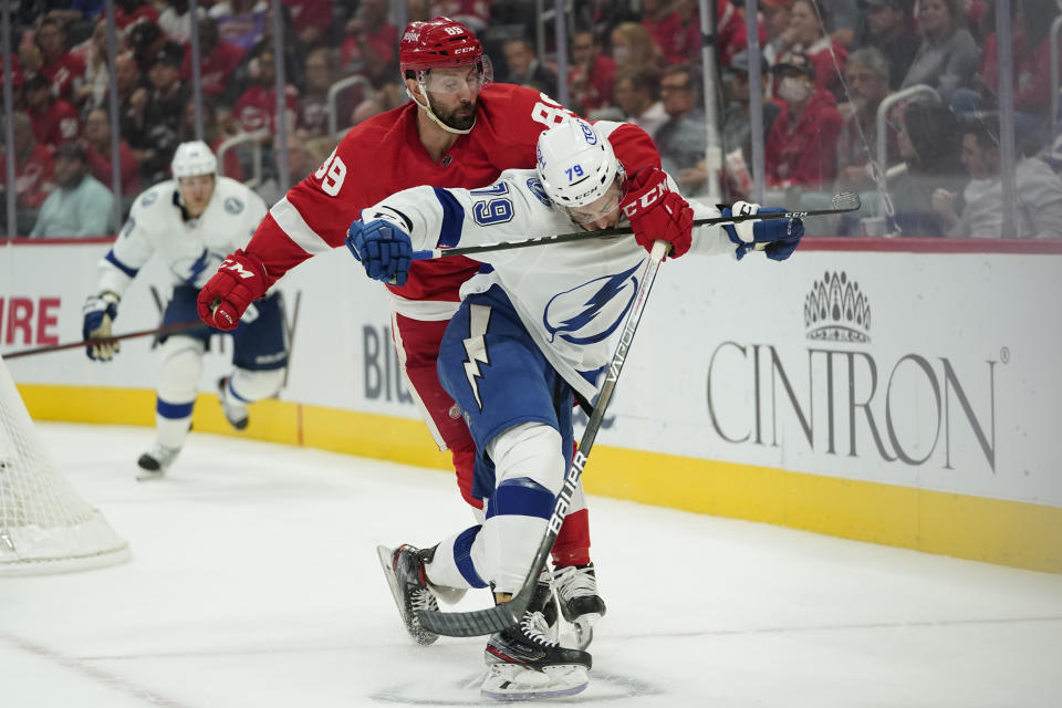 Detroit Red Wings center Sam Gagner (89) and Tampa Bay Lightning center Ross Colton (79) battle for position in the first period of an NHL hockey game Thursday, Oct. 14, 2021, in Detroit. (AP Photo/Paul Sancya)