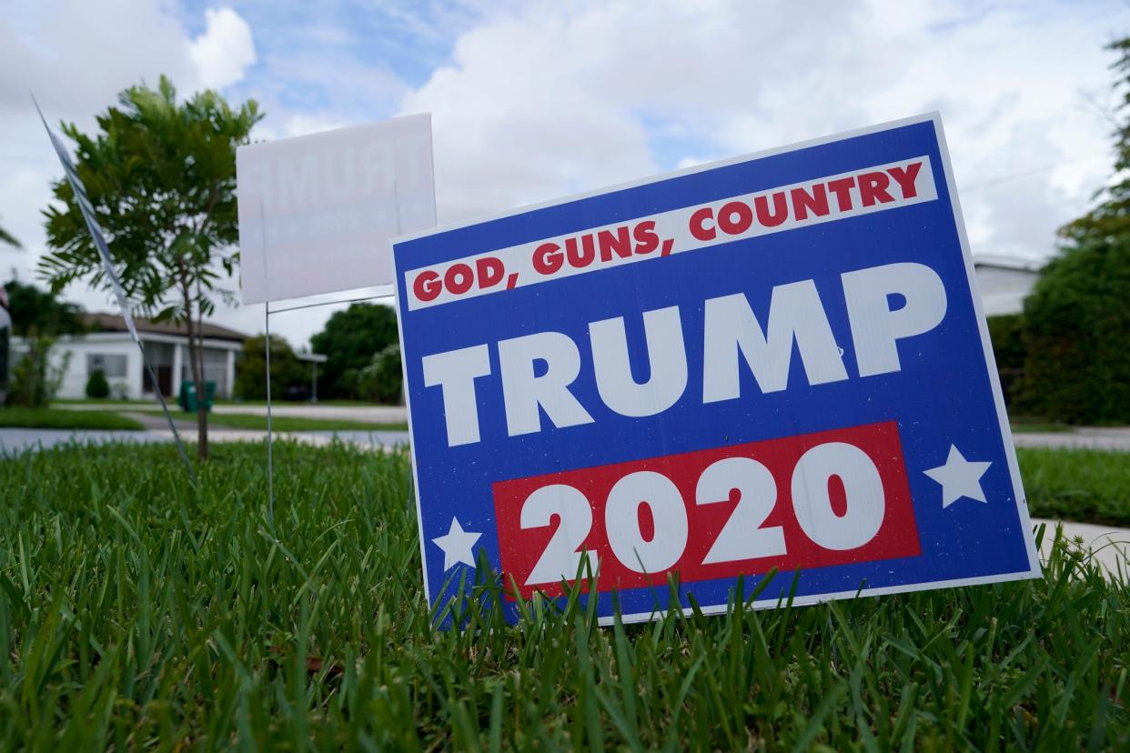 A campaign sign in support of President Donald Trump sits on a lawn Thursday, Oct. 22, 2020, in a Hispanic neighborhood of Miami. Florida's Cuban American voters remain a bright spot in Trump's effort to retain his winning coalition from 2016. Polls show his strong support from these key voters may even be growing to include the younger Cuban Americans that Democrats once considered their best hope of breaking the GOP's hold. (AP Photo/Lynne Sladky)