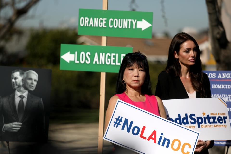 Two women hold campaign signs