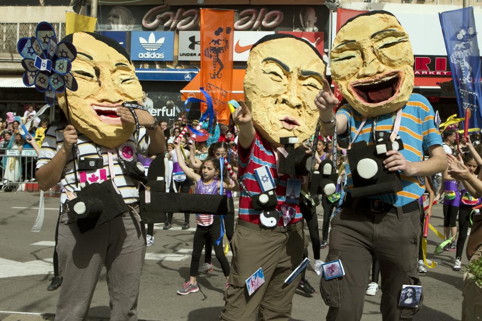 Dressed up Israelis take part in a parade to celebrate the Jewish holiday of Purim on February 24, 2013 in the central Israeli city of Netanya. (Jack Guez/AFP/Getty Images)