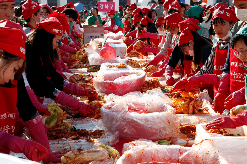 People make traditional Korean side dish kimchi, or fermented cabbage, during the Seoul Kimchi Festival in central Seoul, South Korea, November 2, 2018.   REUTERS/Kim Hong-Ji