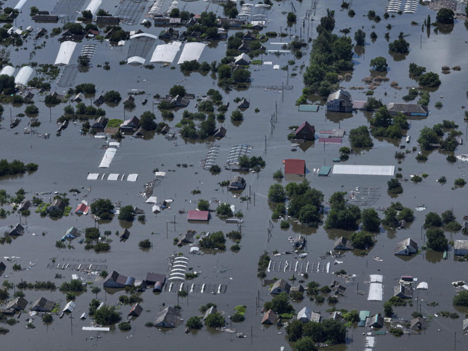 CAPTION CORRECTS LOCATION - Houses are seen underwater in the flooded village of Dnipryany, in Russian-occupied Ukraine, Wednesday, June 7, 2023, after the collapse of Kakhovka Dam. (AP Photo)