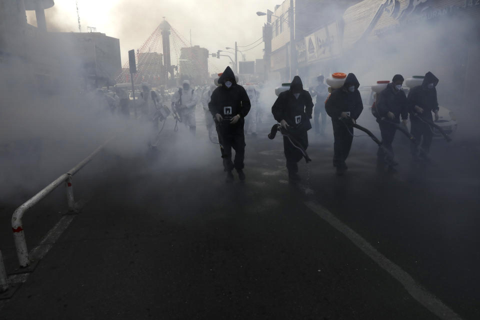 Firefighters disinfect a street against the new coronavirus, in western Tehran, Iran, Friday, March 13, 2020. The new coronavirus outbreak has reached Iran's top officials, with its senior vice president, Cabinet ministers, members of parliament, Revolutionary Guard members and Health Ministry officials among those infected. The vast majority of people recover from the new coronavirus. According to the World Health Organization, most people recover in about two to six weeks, depending on the severity of the illness. (AP Photo/Vahid Salemi)