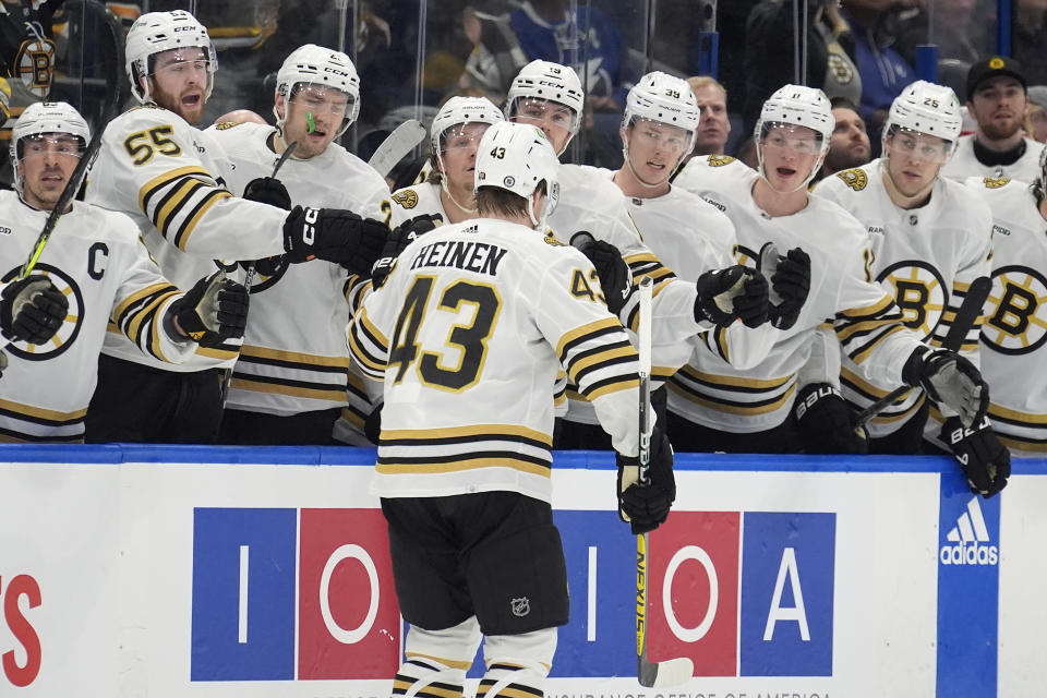 Boston Bruins left wing Danton Heinen (43) celebrates with the bench after his goal against the Tampa Bay Lightning during the first period of an NHL hockey game Wednesday, March 27, 2024, in Tampa, Fla. (AP Photo/Chris O'Meara)