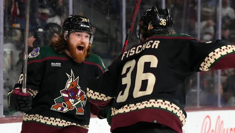 Arizona Coyotes center Liam O'Brien celebrates with right wing Christian Fischer (36) after scoring a goal against the Vancouver Canucks during the first period of an NHL hockey game Thursday, April 13, 2023, in Tempe, Ariz. (AP Photo/Rick Scuteri)