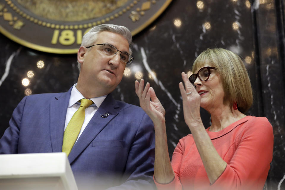 FILE - Indiana Gov. Eric Holcomb speaks with Lt. Gov. Suzanne Crouch as he delivers his State of the State address to a joint session of the legislature at the Statehouse, Tuesday, Jan. 14, 2020, in Indianapolis. Crouch formally started her 2024 campaign for governor on Monday, Dec. 12, 2022, and said she would not shy away from Holcomb's record despite discontent among many conservatives over his COVID-19 policies and other actions. (AP Photo/Darron Cummings, File)