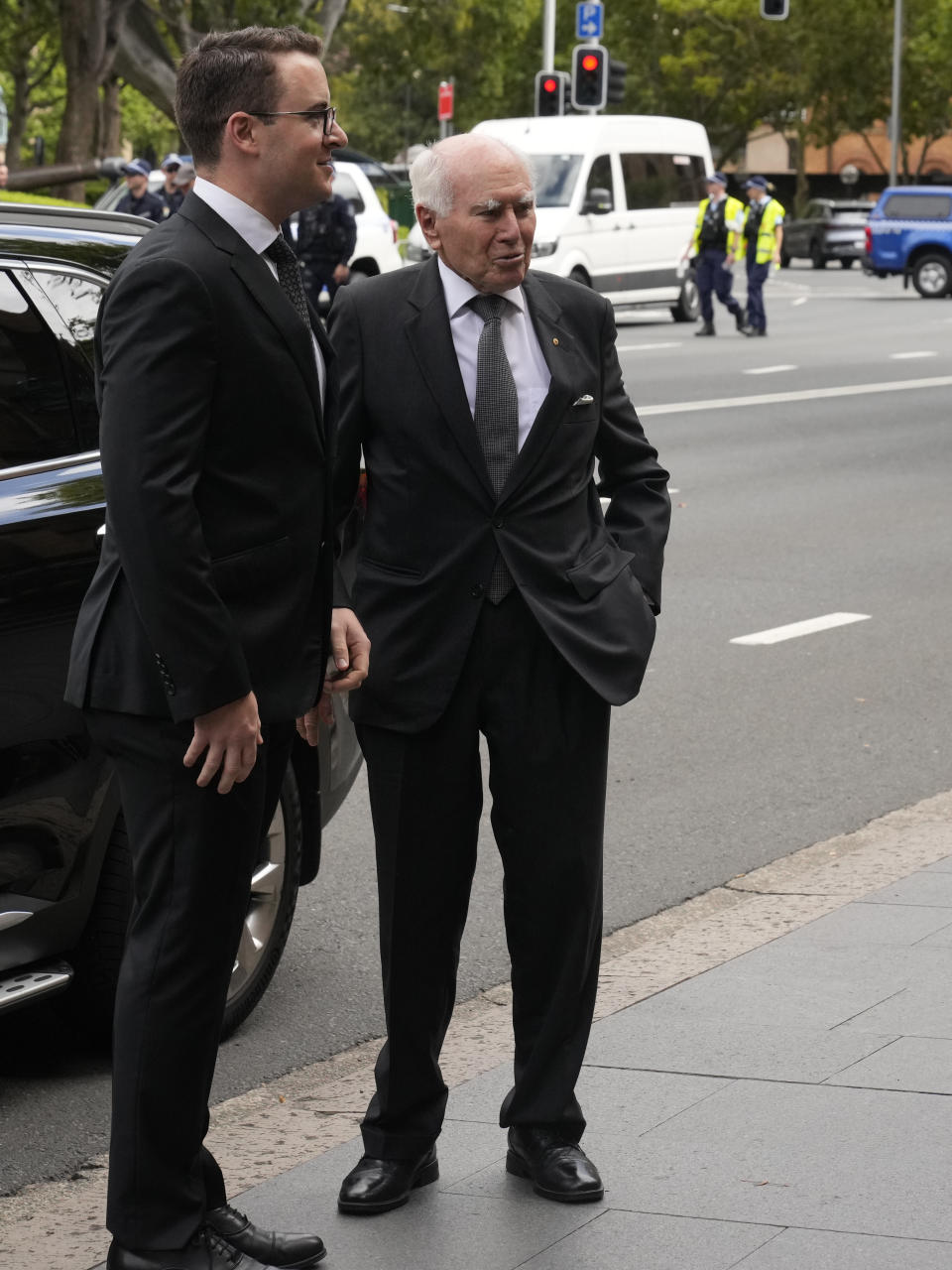 Former Australian Prime Minister John Howard, right, arrives for the funeral and interment of polarizing Cardinal George Pell is under way at St. Mary's Cathedral in Sydney, Thursday, Feb. 2, 2023. Pell, who died last month at age 81, spent more than a year in prison before his sex abuse convictions were overturned in 2020. (AP Photo/Rick Rycroft)