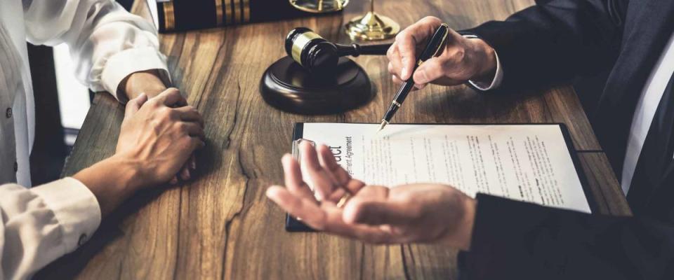 Close up of person consulting a lawyer, hands gesturing