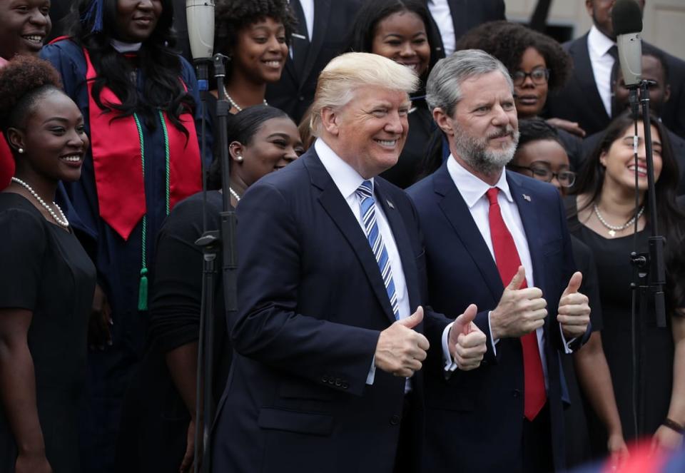 <div class="inline-image__caption"><p>President Donald Trump (L) and Jerry Falwell (R), President of Liberty University, pose for photos with members of gospel choir Lu Praise during a commencement at Liberty University on May 13, 2017, in Lynchburg, Virginia. </p></div> <div class="inline-image__credit">Alex Wong/Getty</div>