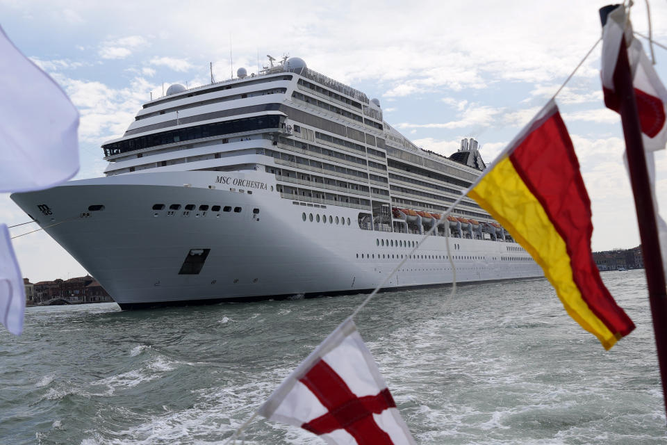 The the 92,409-ton, 16-deck MSC Orchestra cruise ship exits the lagoon as it leaves Venice, Italy, Saturday, June 5, 2021. The first cruise ship leaving Venice since the pandemic is set to depart Saturday amid protests by activists demanding that the enormous ships be permanently rerouted out the fragile lagoon, especially Giudecca Canal through the city's historic center, due to environmental and safety risks. (AP Photo/Antonio Calanni)