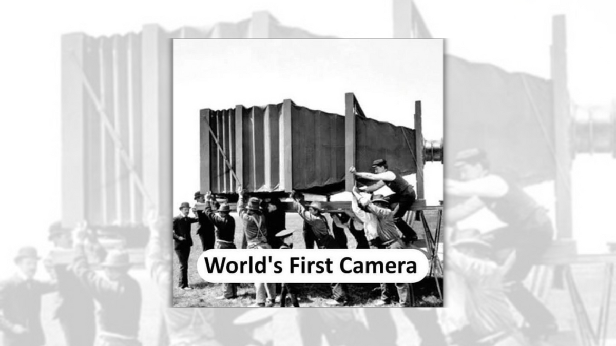 A black-and-white photo shows a massive camera, with many people surrounding it. At the bottom of the photo, it says, "World