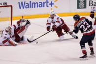 Carolina Hurricanes defenseman Brett Pesce (22) and goaltender James Reimer (47) attempt to defend a shot on goal by Florida Panthers center Carter Verhaeghe (23) during the third period at an NHL hockey game, Saturday, Feb. 27, 2021, in Sunrise, Fla. The Hurricanes defeated the Panthers 4-3. (AP Photo/Marta Lavandier)