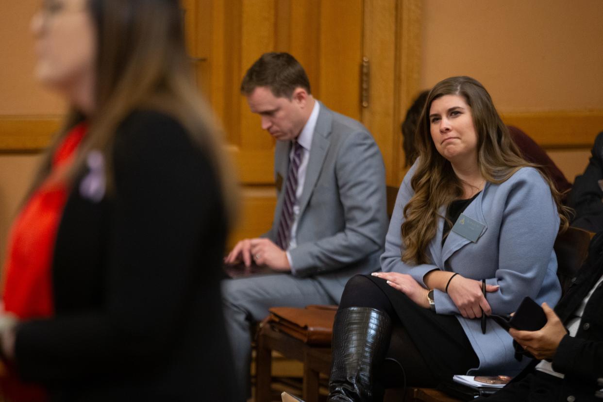 Brittany Jones, a lobbyist for Kansas Family Voice, listens to opponents of legislation that would ban doctors from providing gender affirming care to trans youth during a committee hearing Thursday, Feb. 29, 2024, at the Kansas Statehouse. Jones is a proponent of the bill.