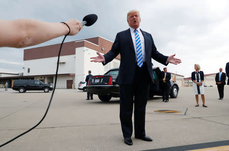 U.S. President Donald Trump speaks to the news media about the federal conviction of his former presidential campaign chairman Paul Manafort as the president arrives for a campaign event in Charleston, West Virginia, U.S. August 21, 2018. REUTERS/Leah Millis