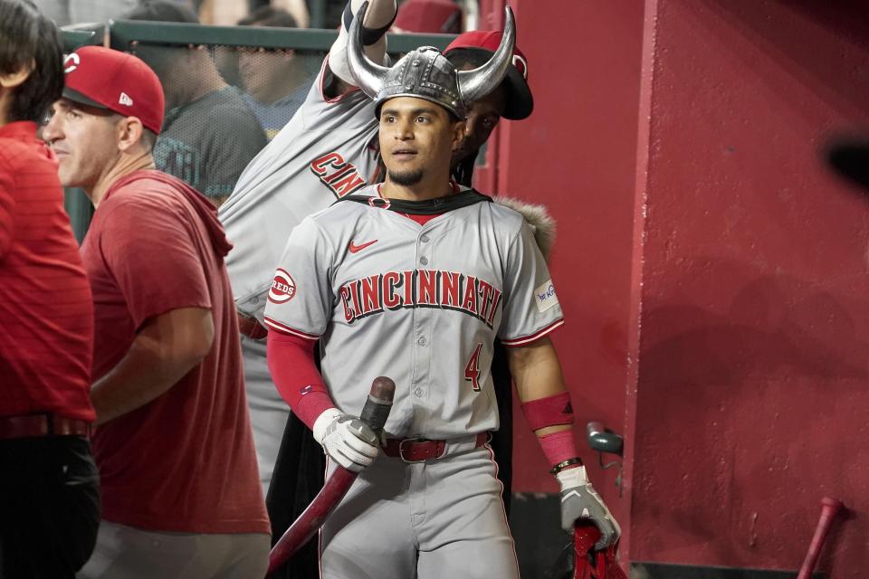 Cincinnati Reds second base Santiago Espinal (4) wears Viking horns after a hitting a home run against the Arizona Diamondbacks during the fifth inning of a baseball game Wednesday, May 15, 2024, in Phoenix. (AP Photo/Darryl Webb)