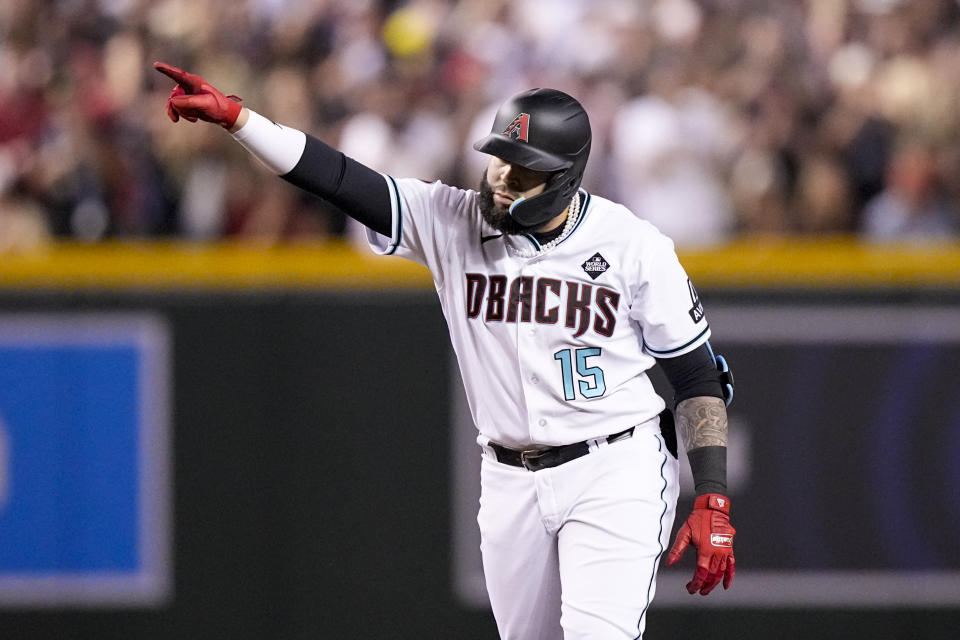 Arizona Diamondbacks' Emmanuel Rivera celebrates after a double against the Texas Rangers during the eighth inning in Game 3 of the baseball World Series Monday, Oct. 30, 2023, in Phoenix. (AP Photo/Brynn Anderson)