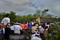 <p>Balinese Hindus take part in a ceremony, where they pray near Mount Agung in hope of preventing a volcanic eruption, in Muntig village of the Kubu sub-district in Karangasem Regency on Indonesia’s resort island of Bali on Nov. 26, 2017. (Photo: Sonny Tumbelaka/AFP/Getty Images) </p>