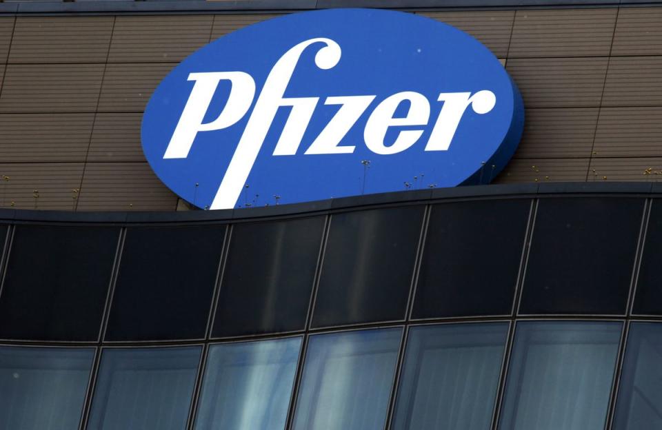 A Pfizer Inc. logo is seen on the company’s German headquarters in Berlin, Germany, on Tuesday, May 25, 2010. Pfizer Inc. will close eight manufacturing plants and scale back operations at six other sites worldwide, eliminating 6,000 jobs as part of a previously announced plan to trim its workforce. Photographer: Michele Tantussi