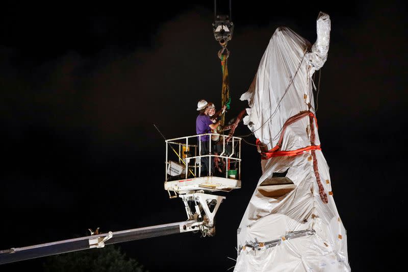 Crew members remove Christopher Columbus statue in Chicago