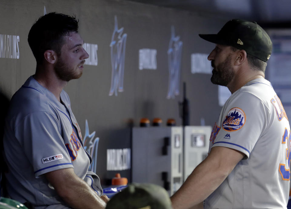 New York Mets starting pitcher Steven Matz, left, left talks with manager Mickey Callaway after being relieved in the fourth inning during a baseball game against the Miami Marlins, Saturday, May 18, 2019, in Miami. (AP Photo/Lynne Sladky)