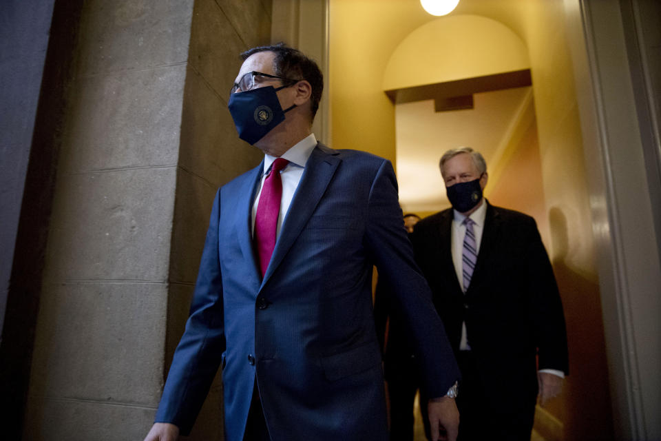 Treasury Secretary Steven Mnuchin, left, and White House Chief of Staff Mark Meadows, right, walk to speak to reporters after meeting with House Speaker Nancy Pelosi of Calif. and Senate Minority Leader Sen. Chuck Schumer of N.Y. as they continue to negotiate a coronavirus relief package on Capitol Hill in Washington, Friday, Aug. 7, 2020. (AP Photo/Andrew Harnik)