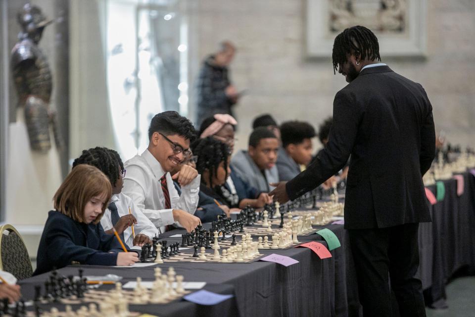 International Master Justus Williams plays chess simultaneously against selected members of the Detroit City Chess Club in the Great Hall at the Detroit Institute of Arts in Detroit on Friday, Dec. 8, 2023.