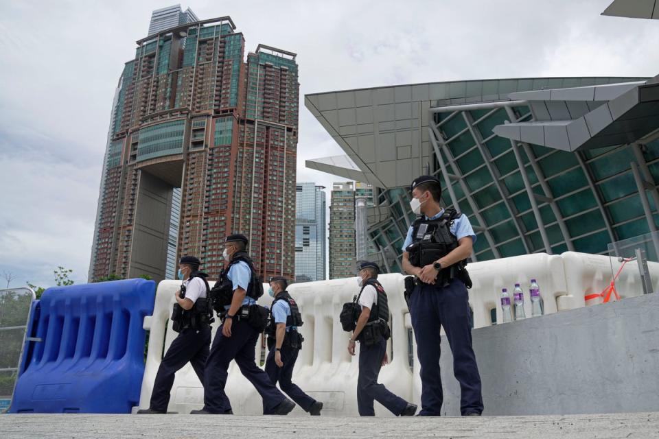 Police officers patrol outside the high speed train station for Chinese president Xi Jinping’s visit (AP)