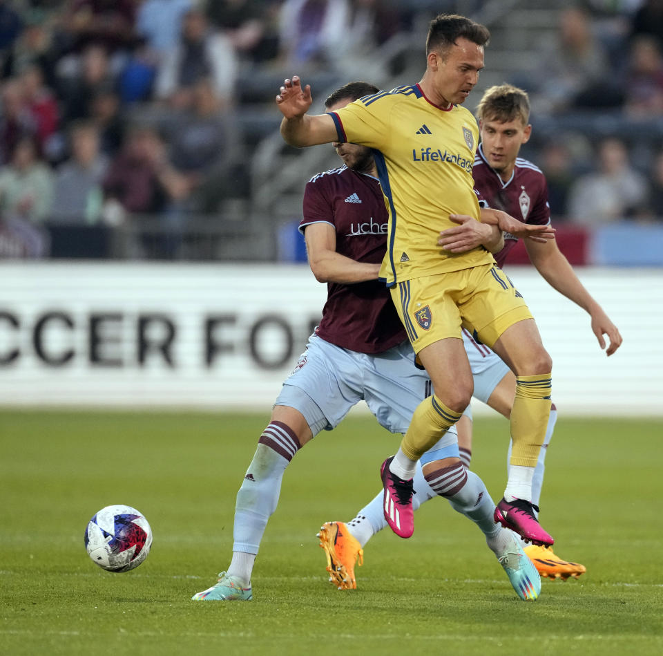 Real Salt Lake forward Danny Musovski, front, gets tangled up with Colorado Rapids defender Danny Wilson in the first half of an MLS soccer match, Saturday, May 20, 2023, in Commerce City, Colo. (AP Photo/David Zalubowski)